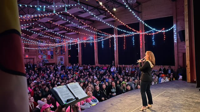 Kate Beirness, TSN SportsCentre host, photographed on stage speaking to a full audience at CSLC 2024, Haliburton