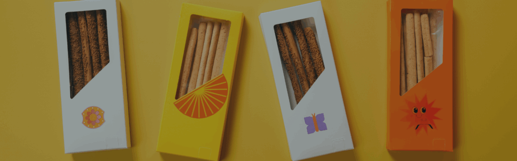 Four colourful snack boxes lined up next to each other.